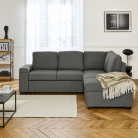 Canapé d'angle convertible. 3 places en tissu gris foncé avec pouf