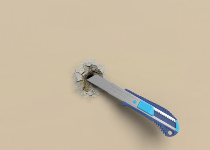 cutter qui enlève le trop plein de plâtre dans le mur