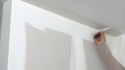 Personne qui applique l'enduit de finition au plafond