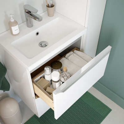 Tiroir ouvert d'un petit meuble de salle de bain blanc