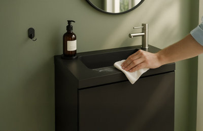 personne nettoyant lavabo noir