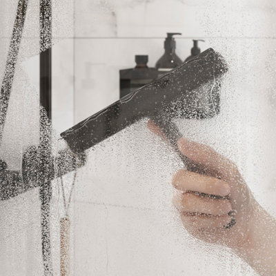 Une raclette passée sur une porte de douche