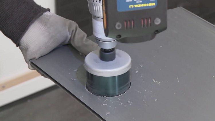 A la scie cloche, découpe du lambris PVC selon la mesure des différentes prises et interrupteurs