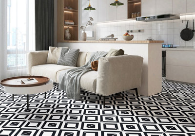Un PVC imitation carreaux de ciment avec des figures géométriques noires et blanches dans un salon avec une cuisine ouverte