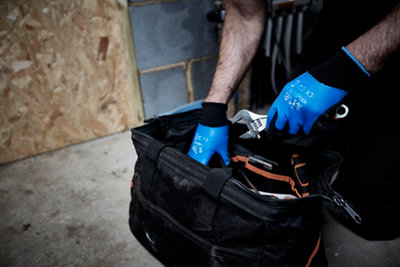 Un homme fouille dans son sac à outils