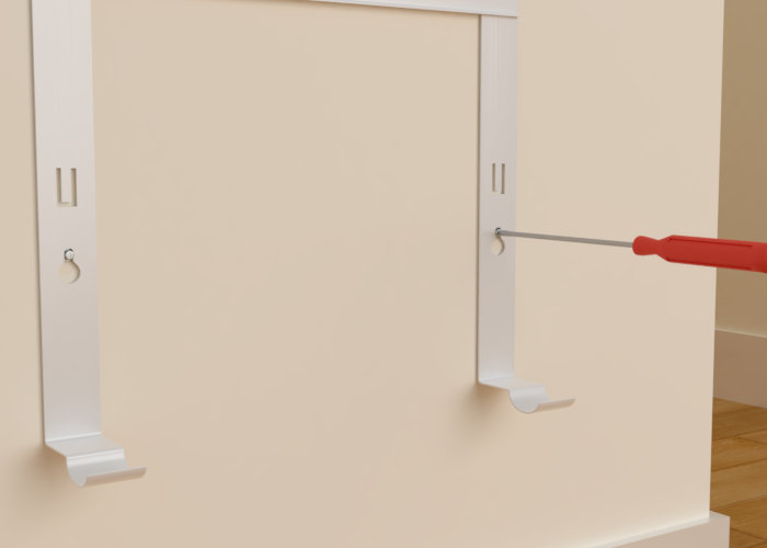 Fixation support radiateur au mur avec tournevis.