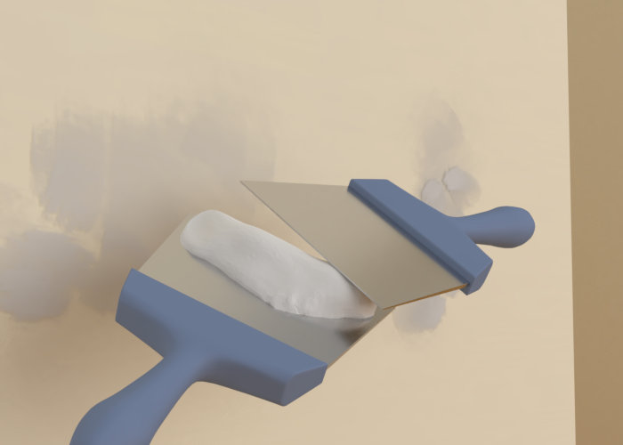 travaille de l'enduit avec spatule.